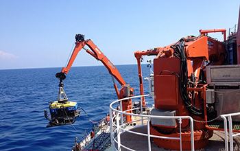 The remotely operated vehicle Jason being lowered into the water from the research vessel.